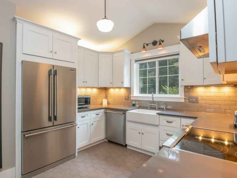 A stainless French-door refrigerator built into a fitted kitchen alongside the dishwasher and sink